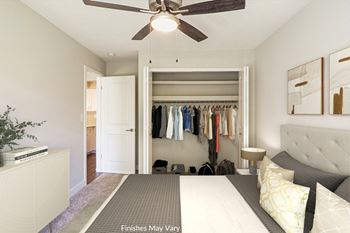 A bedroom with a closet and a ceiling fan